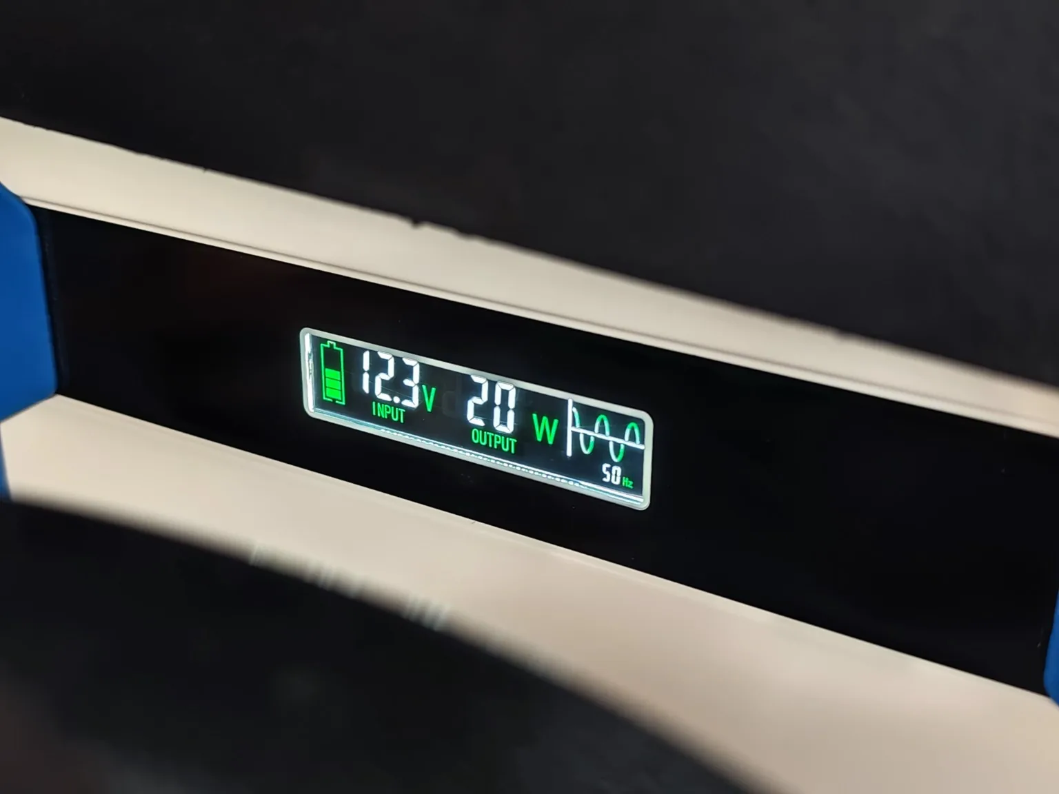 Pure sine wave inverter display showing vehicle input voltage and AC output